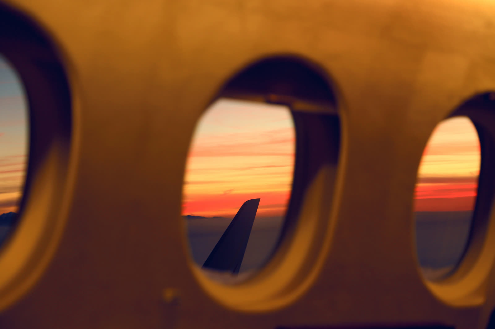 Sunset horizon seen through cabin portholes
