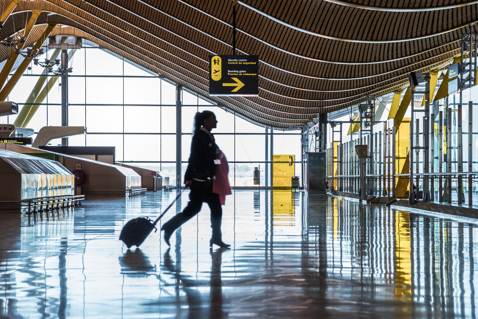 Traveler crossing a sunlit spaceport terminal